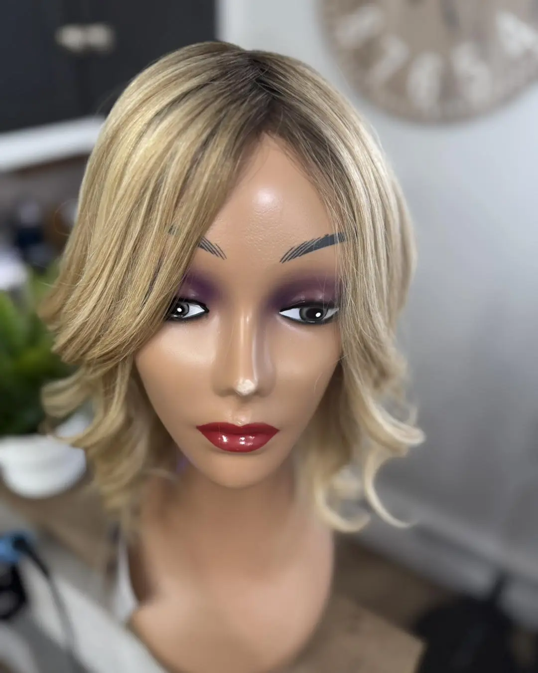 A blonde bob wig on a mannequin head in the salon